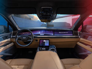 Forward-facing view of Cadillac ESCALADE IQ interior and 55-inch pillar-to-pillar screen from the rear seat.